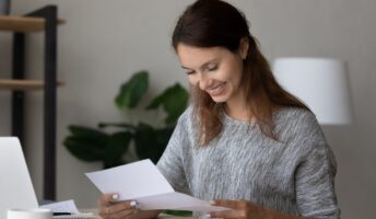 Woman reading a grant approval letter