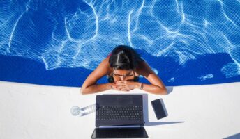 Woman working by the pool