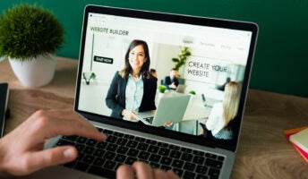 Young professional gets started building a website on laptop