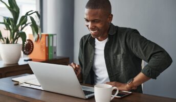 man smiling looking at laptop