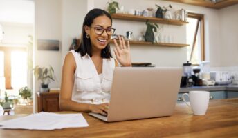 Happy remote worker smiling at screen