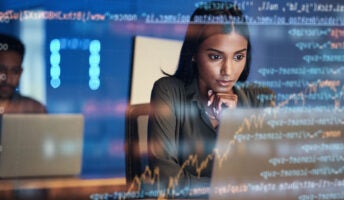 Woman sitting at laptop overlaid by data and code to illustrate IT and cybersecurity statistics