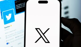 X logo on phone screen