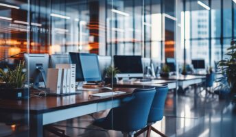 Desks, chairs and monitors in a sleek company office