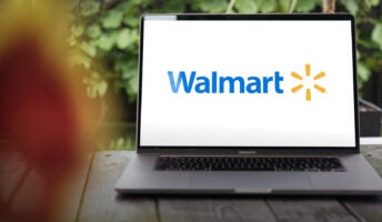 Walmart logo open on laptop screen on porch of house of remote worker