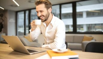 A man drinks coffee at work.