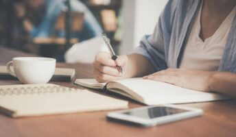 Learning online and writing in a notebook